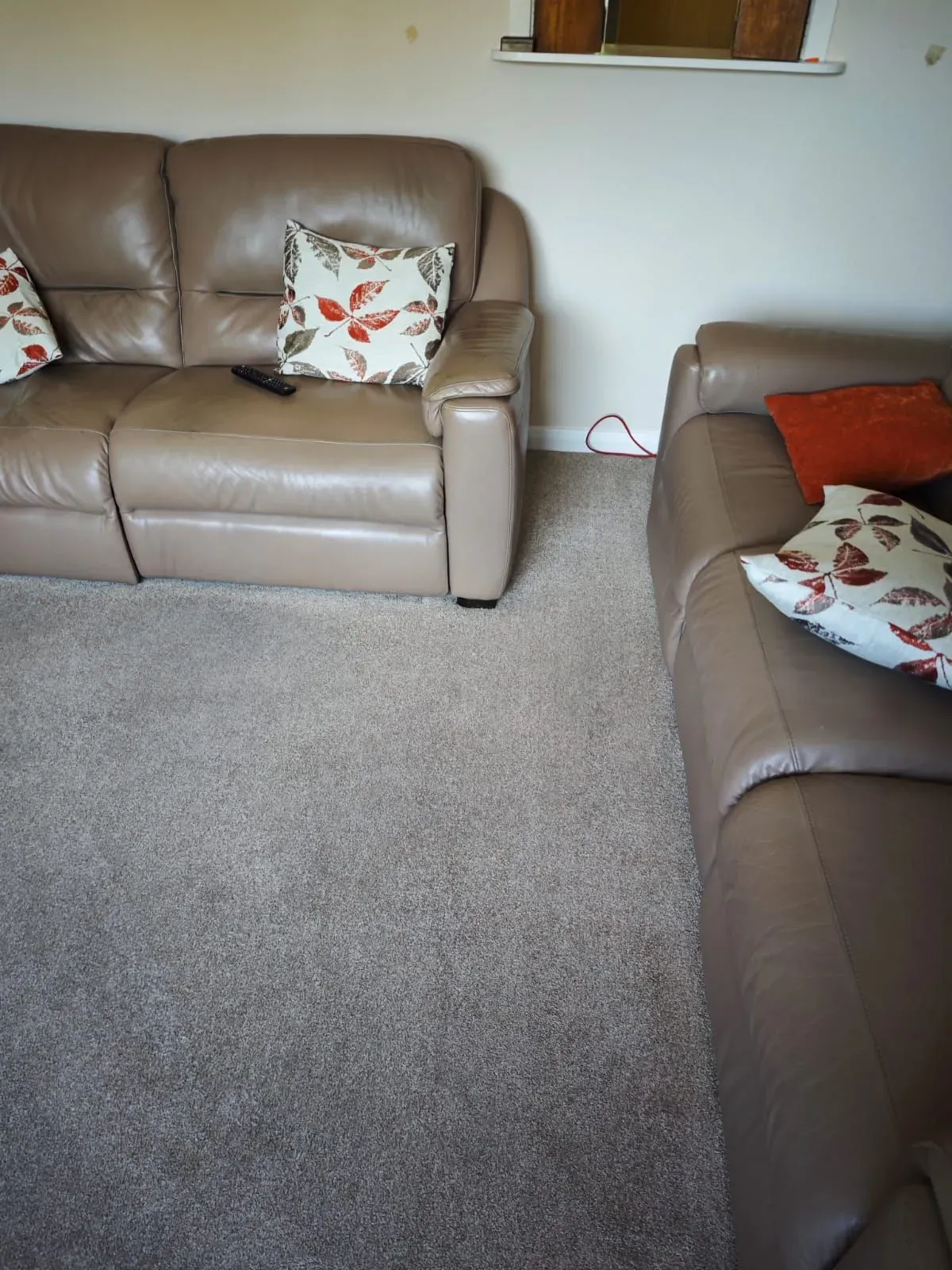 After: living room carpet refreshed around the furniture